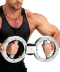 Rotating Burn Machine 12 Lb Arm Trainer With 360 Degree Grips Multifunction Spinning Rotator For Forearms Boxing And Workouts Adjustable Resistance Compact Home Gym Gear For Strength Endurance And Cardio in use, showing a man gripping dual circular handles designed for strength training and endurance workouts.