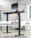 Vivo Black Height Adjustable Standing Desk 71x30 Inch Electric Sit Stand Workstation with computer and lamp in home office.