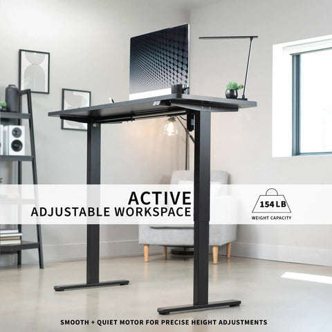 Vivo Black Height Adjustable Standing Desk 71x30 Inch Electric Sit Stand Workstation with computer and lamp in home office.