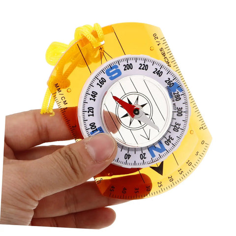 Hand holding Orienteering Compass With Luminous Pointer For Hiking And Outdoor Adventures Compact Acrylic Design Ultra Lightweight