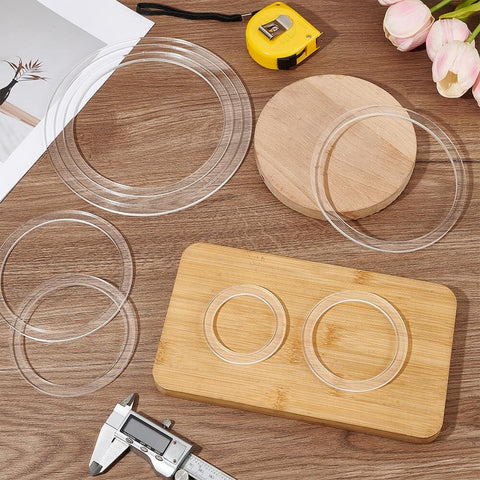 Eight Piece Circle Router Template Set For Woodworking, clear acrylic inlay guides ranging from 2.8 to 8 inches on wooden table.