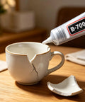 Heavy Duty Clear Industrial Glue Delivers A Hella Tough Bond And Precision Needle Tip For Jewelry Rhinestone Crafts Cell Phone Screen Repairs And Smooth Diy Projects applied to a cracked white ceramic cup for repair.