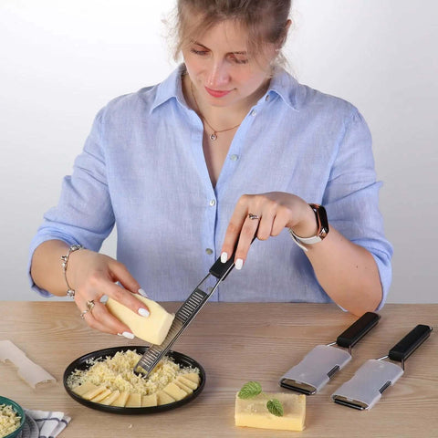 Person using Three Piece Grater And Zester Set With Fine Coarse And Extra Coarse Holes Stainless Steel Dishwasher Safe on cheese