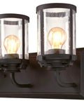 Close-up of three light indoor vanity light wall fixture in oil rubbed bronze with clear seeded glass for bathrooms or hallways.