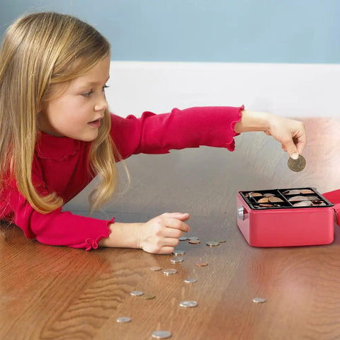 Girl placing coin in small pink cash box with key lock, double layer metal money box for home security, portable locking cash safe with tray.