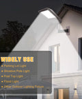 Beefy Heavy Duty 90 Degree Wall Mount Bracket with 2-3/8in OD Tenon installed on building, illuminating with LED light, dark bronze finish.