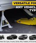 Pair of silver 3-ton jack stands supporting a car's undercarriage beside a yellow floor jack.