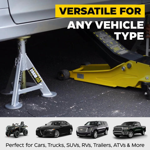 Pair of silver 3-ton jack stands supporting a car's undercarriage beside a yellow floor jack.