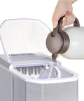 Portable Slick Countertop Ice Maker With Fast Bullet Ice Cubes Ready In Eight Minutes and 33 Pounds Daily For Kitchen Bar Or Game Room Chill Setup filling with water.