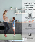 Woman and child on light green Comfy Anti Fatigue Kitchen Mat 17x59, non slip memory foam, for standing long hours in kitchen.