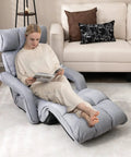 Person relaxing on a Foldable Floor Lazy Cozy Sofa Indoor Chaise Lounge With 6 Adjustable Backrest Positions And 8 Footrest Levels Folding Chair Bed With Adjustable Armrests And Rest For Living Room Or Bedroom Grey
