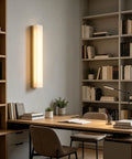 Modern Linear Alabaster Wall Sconce Featuring Polished Copper Base And Three Switchable Color Modes For Chill Bedroom And Living Room Super Sleek Bar Lamp Fixture in calming office setting.