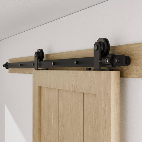 Beefy Heavy Duty Sliding Barn Door Hardware Kit With Top Mount Track In Black Finish Quiet Roller Hanger System For Single Door Supports Up To 220 Lb Hardware Only Door Not Included Includes Rubber Bumpers And Spring Door Stops 60 Inch Length installed on wooden door
