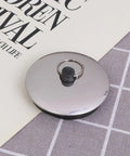 2pcs Rubber Bathtub Drain Stopper Black for Bathroom and Laundry with a smooth metallic surface and rubber grip.