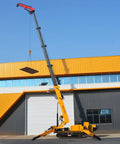 Killer Heavy Duty Hydraulic Crawler Crane With Telescopic Boom And Fly Jib lifting a heavy load against a blue sky.