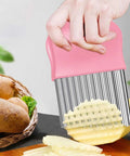 Pink crinkle cutter with stainless steel wavy blade and non-slip handle for kitchen use