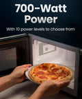 No Sweat Compact Countertop Microwave Oven 0.7 Cubic Foot 700 Watts Fast Heat One Touch Express Cooking with pizza inside.