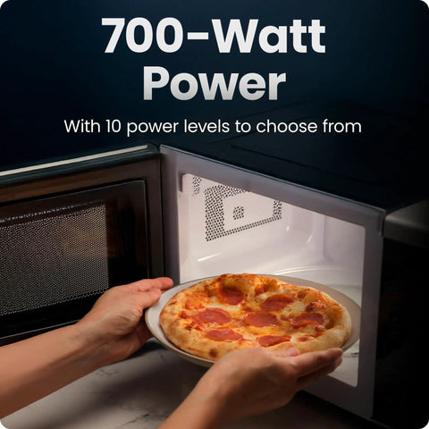 No Sweat Compact Countertop Microwave Oven 0.7 Cubic Foot 700 Watts Fast Heat One Touch Express Cooking with pizza inside.