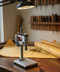 Mini Drill Press Bench Tool With ER11 Chuck And Micrometer on wooden workbench with tools and plans in background