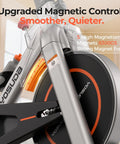YOSUDA exercise bike front view showing magnetic flywheel, grey frame with orange accents.