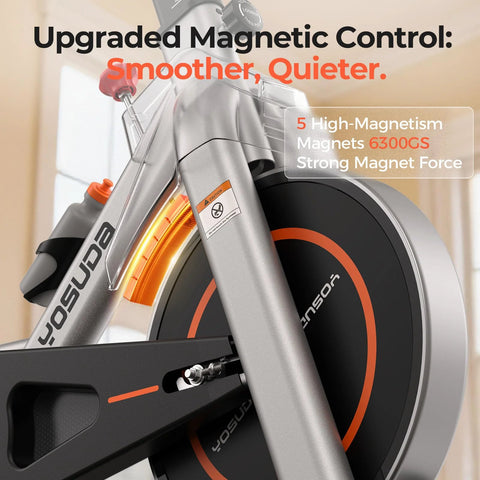 YOSUDA exercise bike front view showing magnetic flywheel, grey frame with orange accents.