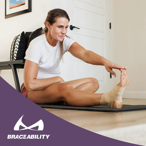 Elastic Ankle Support Sleeve For Men And Women worn by woman stretching, beige small, latex-free for pain relief and recovery.