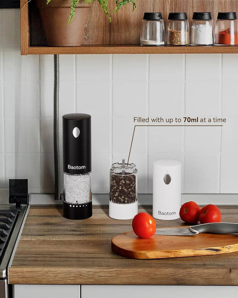Upgraded Electric Salt And Pepper Grinder Set With Dual Charging Base, Rechargeable Operation Eliminates Frequent Battery Replacement For Eco Friendly Convenience In Your Home Kitchen Setup Today on countertop with spices and tomatoes.