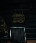 All-In-One Solar Panel Kit For Trail Cameras With Internal Battery on wooden table against dark wall backdrop.