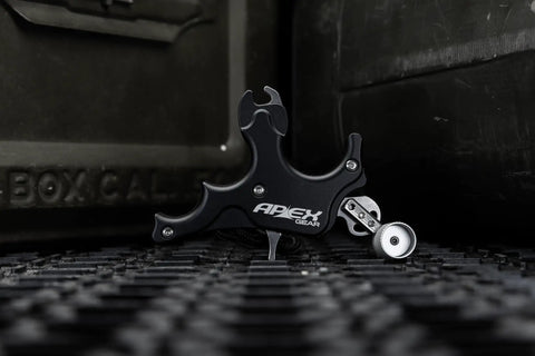 Surge 3 Finger Archery Release Aid With Grooved Finger Beds, CNC Machined Aluminum Case, Thin Head and Jaw, on textured surface