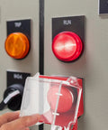 Person opening Emergency Stop Button Cover Box Type Transparent Push Button Switch Shield Heavy Duty Boss Level Protective Housing For 22mm To 33mm Button Diameters Clear Case Made From Glass Resin PC Industrial Grade on control panel.