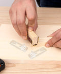 Hands using sanding block near Plastic Shelf Support Pegs Kit 80 Pcs Self Locking Clips For Cabinets And Shelves DIY Friendly Punch Free