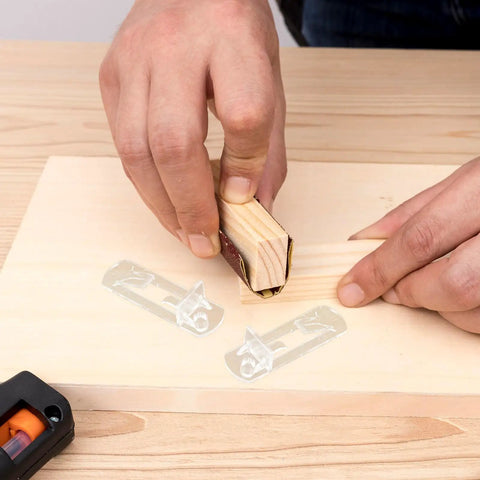 Hands using sanding block near Plastic Shelf Support Pegs Kit 80 Pcs Self Locking Clips For Cabinets And Shelves DIY Friendly Punch Free