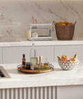 TIDITA 16-inch acacia wood lazy Susan on a metal frame; rotating countertop serving tray with bottles.