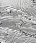 Close-up of heavy duty roof repair tape surface with water droplets, showing aluminum foil for weatherproof gutter fix.