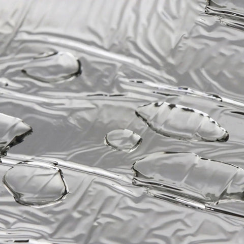 Close-up of heavy duty roof repair tape surface with water droplets, showing aluminum foil for weatherproof gutter fix.