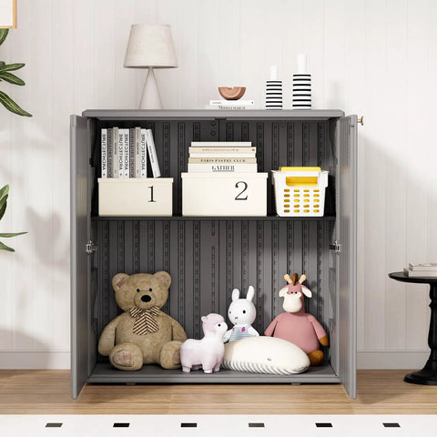 Front view of Beefy Outdoor Storage Cabinet With Doors And Shelf Grey Weatherproof HDPE Resin Box, 34x15x36 inches, storing various items.