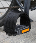 One Pair Velcro Bike Straps For Pedals attached to a bike pedal, showcasing nylon foot binding with reflective tape, no buckles.