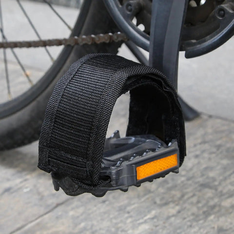 One Pair Velcro Bike Straps For Pedals attached to a bike pedal, showcasing nylon foot binding with reflective tape, no buckles.