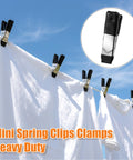 Clothes secured by 2-Inch Heavy-Duty Metal Spring Clamps Set With Non-Slip Rubber Tips under clear sky