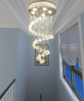 Spiral Crystal Raindrop Chandelier With Five Lights, Modern Flush Mount Round Pendant Lighting in stairway view.