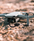 1300Kv Brushless DC Drone Motor Alloy High Performance Replacement for 7 Inch Quadcopters beside a drone on grass