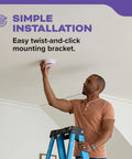 Person installing the Top Shelf Rock Solid Hardwired Smoke And Carbon Monoxide Combo Detector with a twist-and-click bracket.