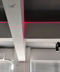 Red Cross Light Alignment Module with Focusable Locator for Screen Printing shown projecting cross lines on a wall.