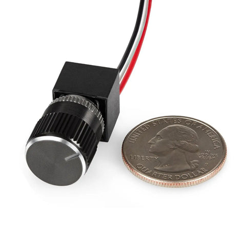 Slick 12 Volt Dc Dimmer Switch For Tight Led And Halogen Control In Rvs Trucks And Marine Gear With Rock Solid Long Shaft Assembly next to a quarter.