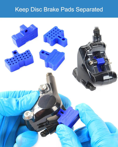 Mechanic using All In One Pro Grade Hydraulic Disc Brake Pad Spacer Set With Three Styles Bleed Blocks on a bike caliper