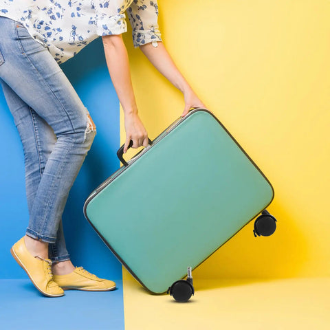 Solid 8 Pack 1.5 Inch Stem Swivel Casters Featuring Strong Locking Brakes For Silky Smooth Roll On Heavy Duty Trash Cans And Utility Carts Quick Swap Universal Dolly Wheels; teal suitcase with black wheels held by a person in blue and yellow background.