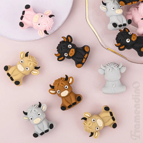 20 Pack Highland Cow Silicone Beads Set For DIY Jewelry And Crafts, colorful cow-shaped spacers on pink surface
