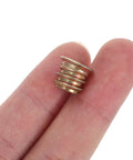 Close-up of a Heavy Duty Threaded Metal Insert with Countersunk Flange M6x10mm held between fingers, ideal for wood and particleboard.