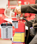 Heavy Duty Aluminum Fire Extinguisher Tags Bulk Pack Featuring Monthly 2026 To 2029 Dates on a red fire extinguisher with inspection record.
