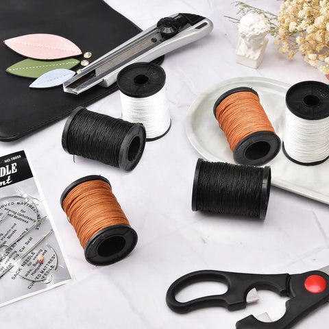 Topus upholstery repair thread kit with heavy-duty hand needles; 3 rolls nylon thread (black, white, orange) on spools.